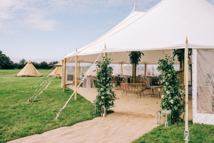 Free standing floral arch way for a sailcloth wedding
