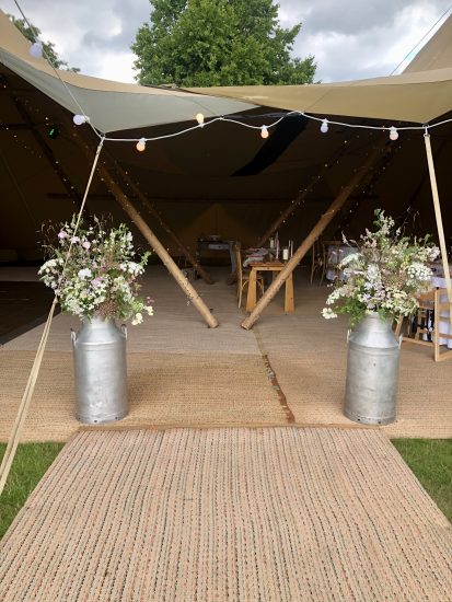 wild flower milk churn arrangements for tipi wedding