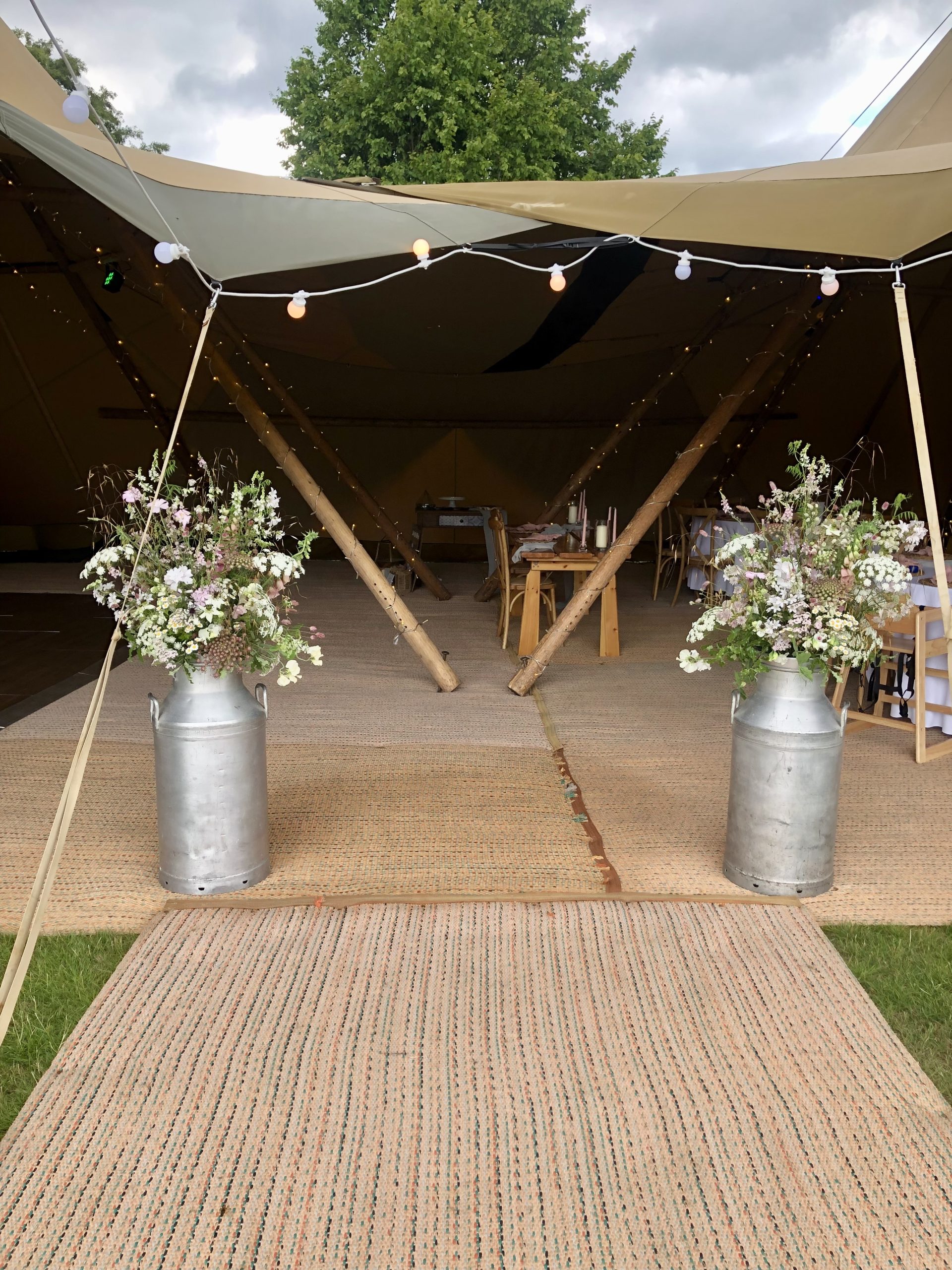 wild flower milk churn arrangements for tipi wedding