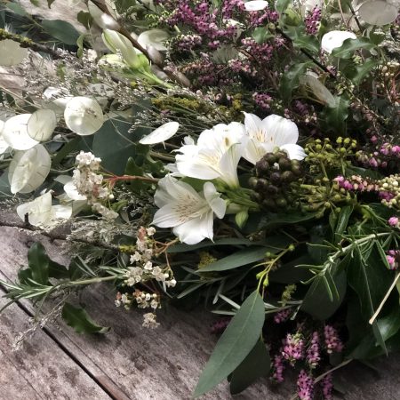 funeral sheaf of greenery and winter flowers
